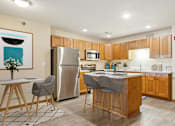 Thumbnail 1 of 29 - A modern kitchen with wooden cabinets and a large island.