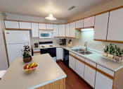Thumbnail 8 of 12 - Kitchen with white paneled cabinets and central island