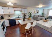 Thumbnail 7 of 12 - Kitchen with attached living and eat at island, white paneled cabinetry