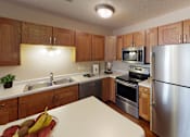 Thumbnail 1 of 12 - Kitchen with light wooden cabinets, central island and stainless steel appliances