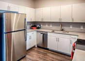 Thumbnail 3 of 24 - Kitchen with Appliances and White Cabinets