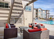 Thumbnail 14 of 24 - Outdoor Poolside Lounge with Chairs and Fireplace