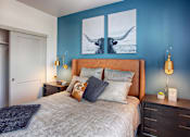 Thumbnail 9 of 24 - Bedroom with Bed, Nightstands and Blue Accent Wall