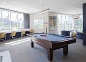 Thumbnail 12 of 29 - a pool table in a room with large windows
