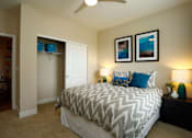 Thumbnail 7 of 29 - Cozy bedroom with walk in closet and natural light flowing in from a window on the wall opposite the closet.