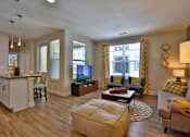 Thumbnail 5 of 29 - Spacious open concept living room with two large windows.