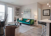 Thumbnail 6 of 29 - Open living area with stylish plank flooring throughout the space and large windows.