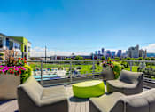 Thumbnail 20 of 29 - Outdoor community lounge deck with comfortable seating looking out onto stunning views of Downtown Denver.