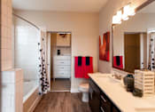 Thumbnail 9 of 29 - Bright and stylish bathroom with a full shower, double vanity sink, and quartz countertops. Bathroom leads into walk in closet.