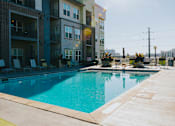 Thumbnail 16 of 29 - a swimming pool in front of an apartment building