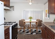 Thumbnail 8 of 24 - a kitchen and dining room with a table and chairs