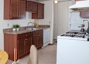 Thumbnail 12 of 24 - a kitchen with a stove top oven and a sink