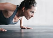 Thumbnail 16 of 24 - a woman is doing a plank on the floor