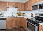 Thumbnail 1 of 29 - Kitchen with Wood Cabinets and White Counter Tops