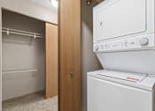 Thumbnail 9 of 29 - A white dryer is in a small laundry room.