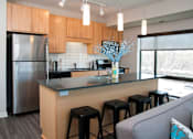 Thumbnail 1 of 18 - Kitchen with stainless steel appliances and granite countertops