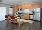 Thumbnail 2 of 18 - Kitchen with island, stainless steel appliances, granite countertops and large windows