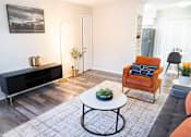 Thumbnail 11 of 32 - a living room with a couch and a coffee table at La Bella Apartments, Fort Worth