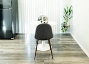 Thumbnail 9 of 32 - a living room with a black refrigerator and a white table at La Bella Apartments, Fort Worth, Texas