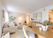 Thumbnail 1 of 29 - A well-lit, modern living room with a neutral color scheme and contemporary furniture.