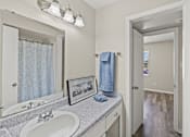 Thumbnail 30 of 32 - A bathroom with a white sink and a mirror above it. at La Bella Apartments, Fort Worth, 76116