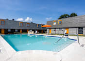Thumbnail 31 of 32 - A large outdoor swimming pool with a sun lounger. at La Bella Apartments, Fort Worth, Texas