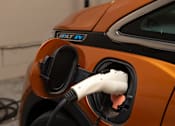 Thumbnail 53 of 57 - An orange car is charging at a 15G charging station.