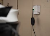Thumbnail 56 of 57 - A black plug is connected to a white outlet.