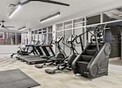 Thumbnail 7 of 55 - A gym with treadmills and elliptical machines.