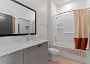 Thumbnail 126 of 144 - A bathroom with a white sink and a white toilet.