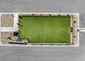 Thumbnail 28 of 74 - an aerial view of a football field in a parking lot at Red Rock Apartments, Rapid City