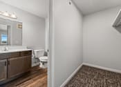 Thumbnail 72 of 74 - A bathroom with a toilet, sink, and mirror. at Red Rock Apartments, Rapid City, SD, 57702