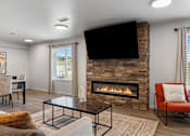 Thumbnail 41 of 74 - a living room with a fireplace and a television at Red Rock Apartments, Rapid City, SD, 57702