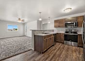 Thumbnail 55 of 74 - a kitchen with wooden cabinets and stainless steel appliances at Red Rock Apartments, Rapid City, SD, 57702
