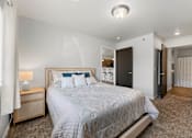 Thumbnail 70 of 74 - a bedroom with a large bed and a closet at Red Rock Apartments, Rapid City, South Dakota