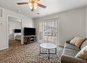 Thumbnail 58 of 74 - a living room with a couch and a coffee table and a tv at Red Rock Apartments, Rapid City, South Dakota