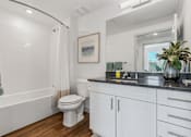 Thumbnail 33 of 35 - a bathroom with a toilet and a sink and a mirror at City View St. George Apartments, St George