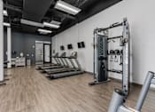 Thumbnail 17 of 35 - a fitness room with treadmills and weights in it at City View St. George Apartments, Utah