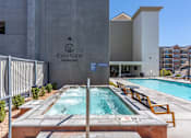 Thumbnail 10 of 35 - a swimming pool in front of a cityview parking building at City View St. George Apartments, St George, Utah