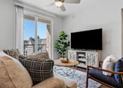 Thumbnail 29 of 35 - a living room with a couch and a tv at City View St. George Apartments, St George