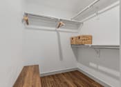 Thumbnail 31 of 35 - a walk in closet with white walls and a wood floor at City View St. George Apartments, St George, UT, 84770