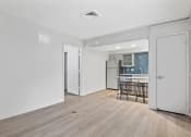 Thumbnail 58 of 61 - the living room and kitchen of an apartment with a hardwood floor and white walls at AVIA Lofts on Liberty Ridge, Jacksonville, FL, 32256