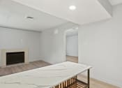 Thumbnail 52 of 61 - a living room with a marble table and a fireplace at AVIA Lofts on Liberty Ridge, Jacksonville, FL, 32256