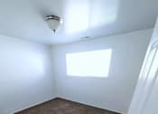 Thumbnail 10 of 14 - A room with a carpeted floor and a window.