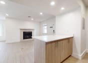 Thumbnail 28 of 34 - a kitchen with a white counter top and a fireplace