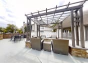 Thumbnail 10 of 34 - a patio with tables and chairs and a pergola