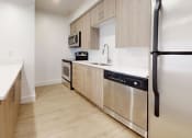 Thumbnail 23 of 34 - a large kitchen with wooden cabinets and stainless steel appliances