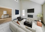Thumbnail 22 of 51 - A living room with a white couch and a fireplace.