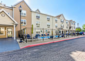 Thumbnail 32 of 45 - A sunny day at a residential building with a playground in front.
