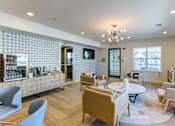 Thumbnail 41 of 45 - A modern living room with a patterned wallpaper and a variety of seating options.